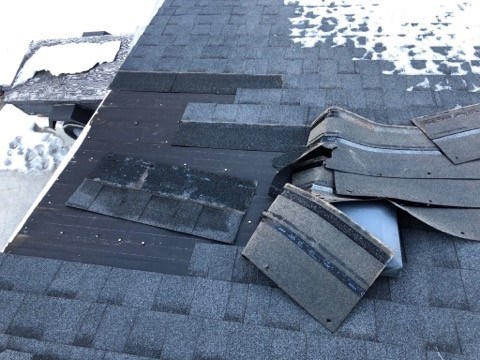 Shingles on a Cochrane resident's roof turned up by strong winds. 