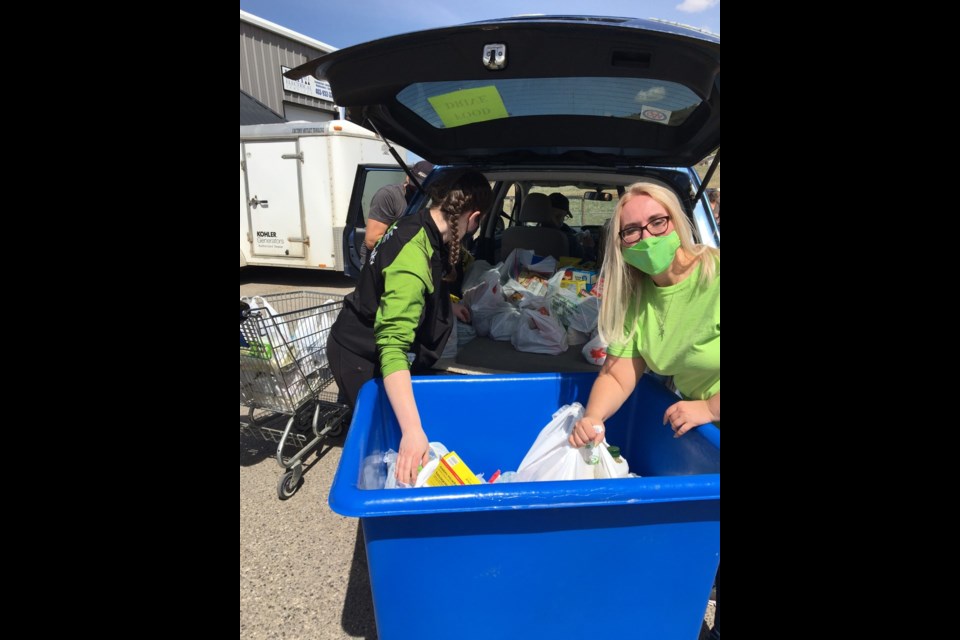 Helping Hands volunteers hosted a food drive Saturday (May 15) to collect donations for the Cochrane Activettes Food Bank. Submitted Photo