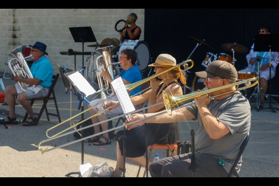 Conductor Adam Mailman and the Cochrane Music Societyâs Band on the Bow concert band host a free music pop-up outdoor concert on Sunday (Aug. 2) in the Cochrane Town Square parking lot. (Chelsea Kemp/The Cochrane Eagle)