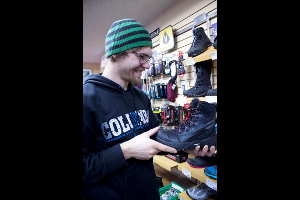 Trailblazers employee Logan Schroader shows off a pair of boots that would be ideal for winter camping. Photo by Cathi Arola