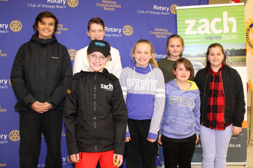 Zach Hofer, 13, of Barrie, stands with Wasaga Beach youth who attended his Rotary Club of Wasaga Beach presentation Monday night. Gisele Winton Sarvis/CollingwoodToday
