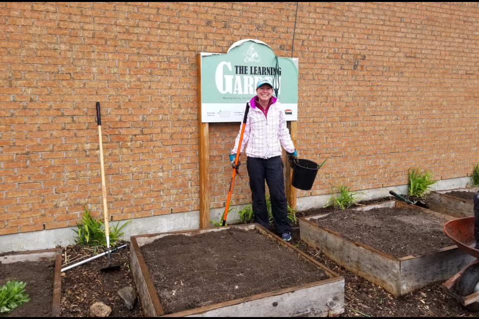 Jessica Lehr plants native species plants at the Learning Garden in Collingwood. Contributed photo