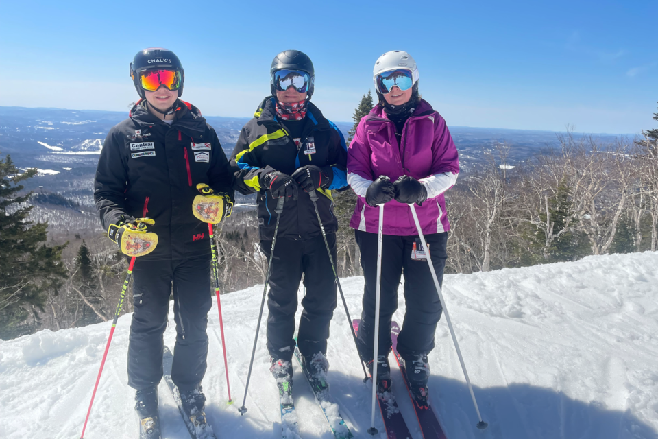 Kris Baird skiing with her son and husband. 