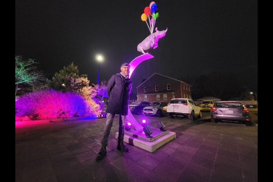 Artist W. W. Hung stands in front of his sculpture Dare to Dream in Tremont Square in Collingwood.