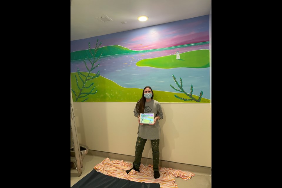 Artist Taylor Wensley shows the completed mural she painted in one of the safe rooms at the Collingwood General and Marine Hospital's emergency department. 