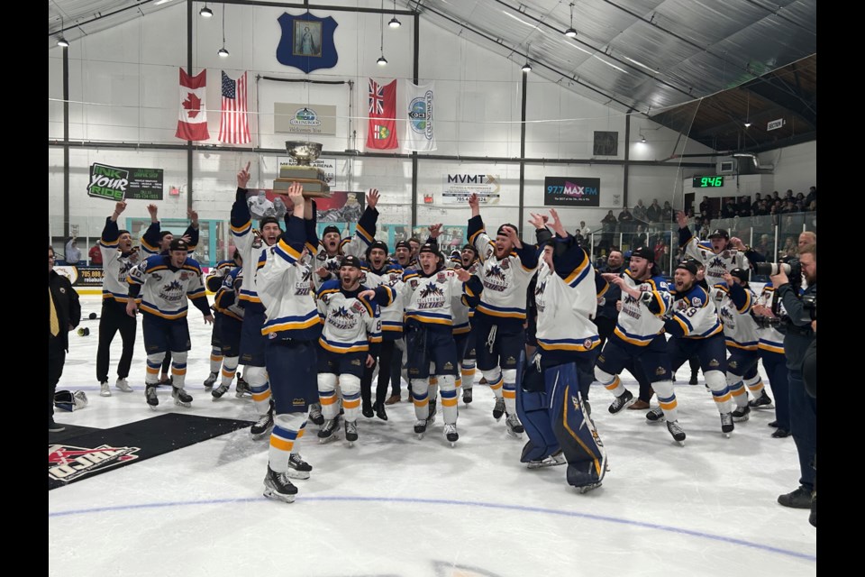 The Collingwood Blues celebrate their dramatic overtime win to become OJHL champions Friday night.