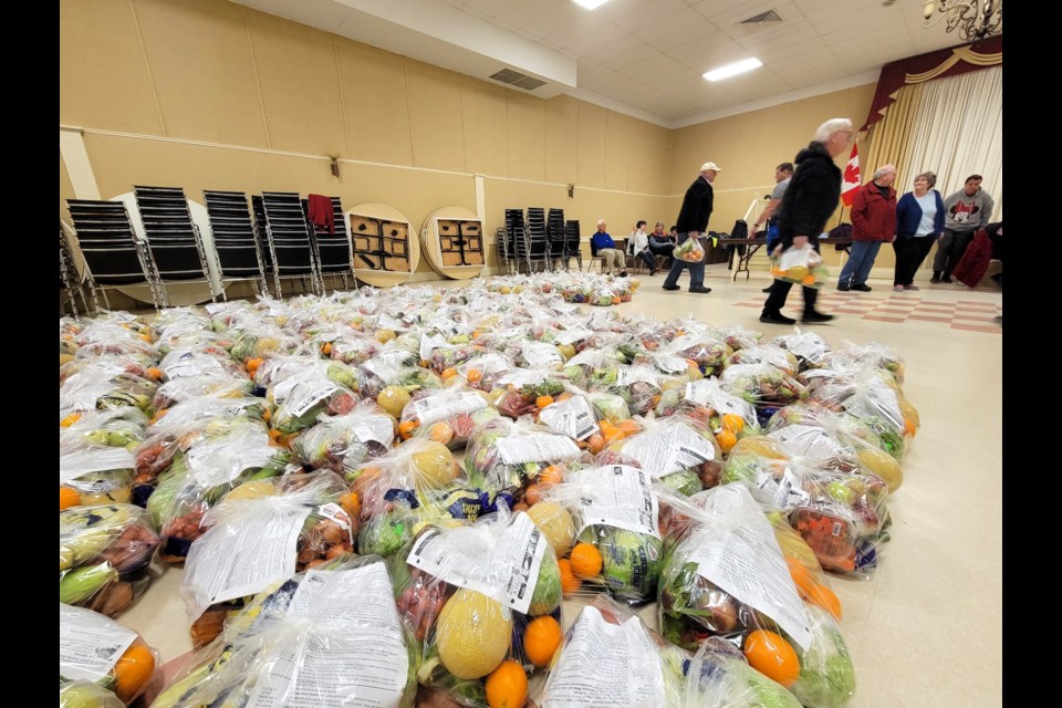 Volunteers carry out prepared bags of food for delivery through the Georgian Good Food Box on April 17 at the Collingwood legion.