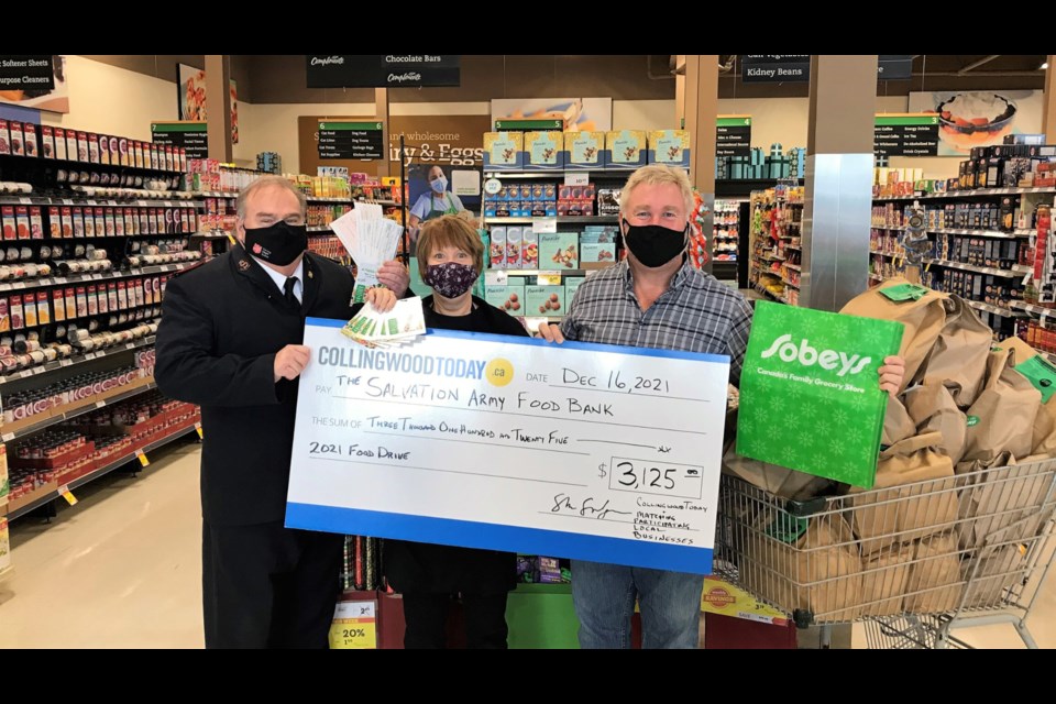 Stuart Snelgrove from CollingwoodToday and Wendy Logan from Sobeys Collingwood deliver cheque to Rob Hardy of the  Salvation Army Collingwood in time for the holidays.