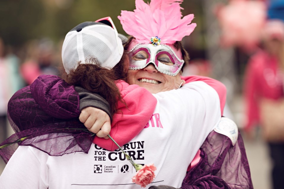 Lyndsey McFarland gets a hug from a friend after walking in the Run for the Cure event in 2017 in Collingwood/ The Blue Mountains. Contributed photo