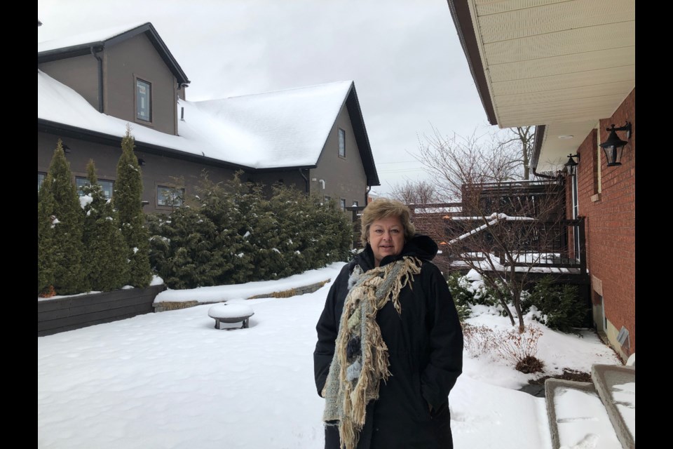 Marg Scheben-Edey stands in her backyard on Smart Court in Collingwood. The newly erected infill home is to her left. Erika Engel/CollingwoodToday
