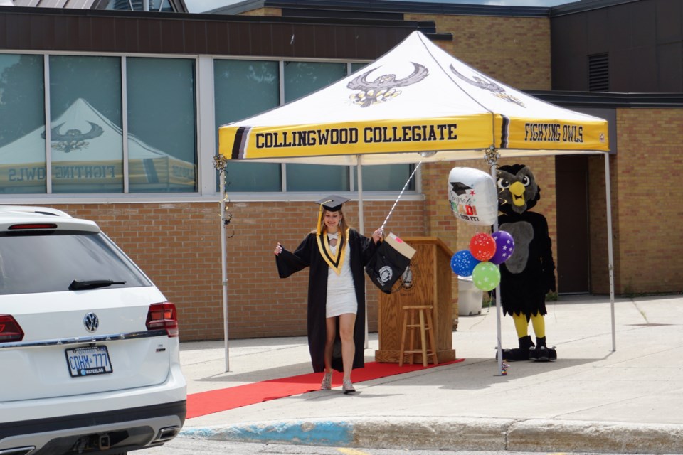 Students only left their vehicles to walk down a red carpet and retrieve their packages at the Collingwood Collegiate Institute's drive-through commencement on Thursday. Jessica Owen/CollingwoodToday