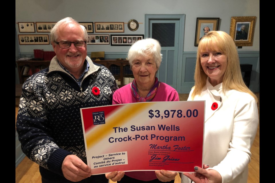 Paul Healy (left) and Carole Allen (right) present a grant for $3,978 to Barb Sneyd for the Susan Wells Crock-Pot Program. Erika Engel/CollingwoodToday