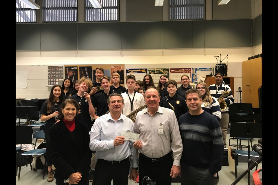Ruth and Charlie Gudaitis present Jean Vanier Catholic High School music teacher Gregory Frackowiak and Principal John Collingbourne with $1,500 for the high school music program from the South Georgian Bay Music Foundation. Contributed Photo