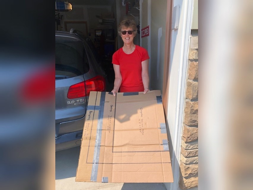 Joanne Sinclair, a resident of Blue Fairway in Collingwood, created a cardboard template of the new County of Simcoe waste collection carts, true to size, to test if they would fit in her single-car garage along with her car.