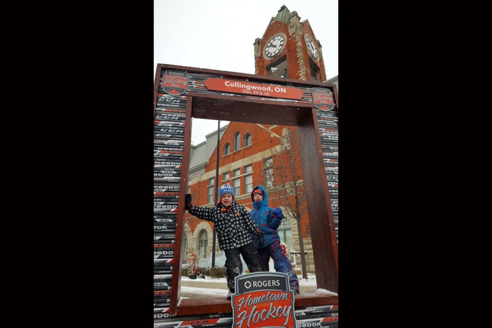 Kids enjoy the photo frame made of hockey sticks at the Hometown Hockey and Frozen in Time festival set up on Hurontario Street. Photo contributed by Glen Card.