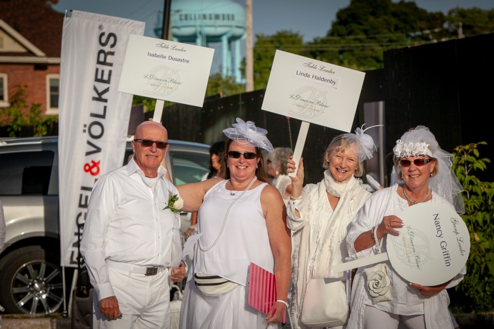Guests who had tickets for Dinner En Blanc were given a rendezvous point. From their they walked to the top-secret event location. Dinner en Blanc, Collingwood, Ontario, 2018. Photo by Sebastian Petrescu, Elevated Photos