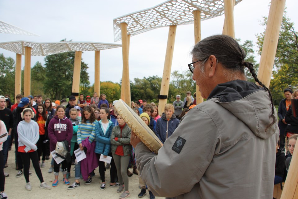 John Rice plays a drum and sings a memorial song for the crowd of students at the Awen Gathering Circle for Orange Shirt Day. Erika Engel/CollingwoodToday