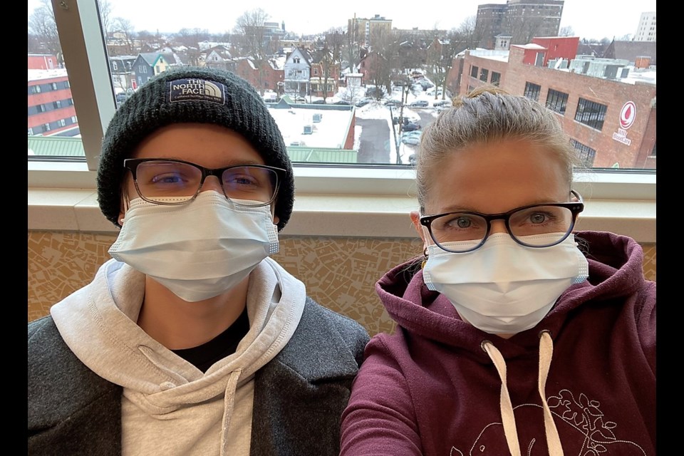 Finn Murphy, left, and his mom Kelly at a recent hospital appointment to treat Finn's cystic fibrosis.
