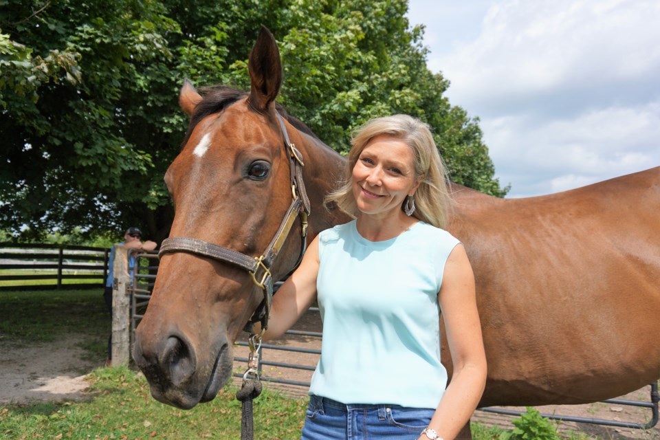 Soreno, a 14-year-old Thoroughbred gelding, is shown with Blue Oaks Counselling and Wellness psychotherapist Julia Lippert.