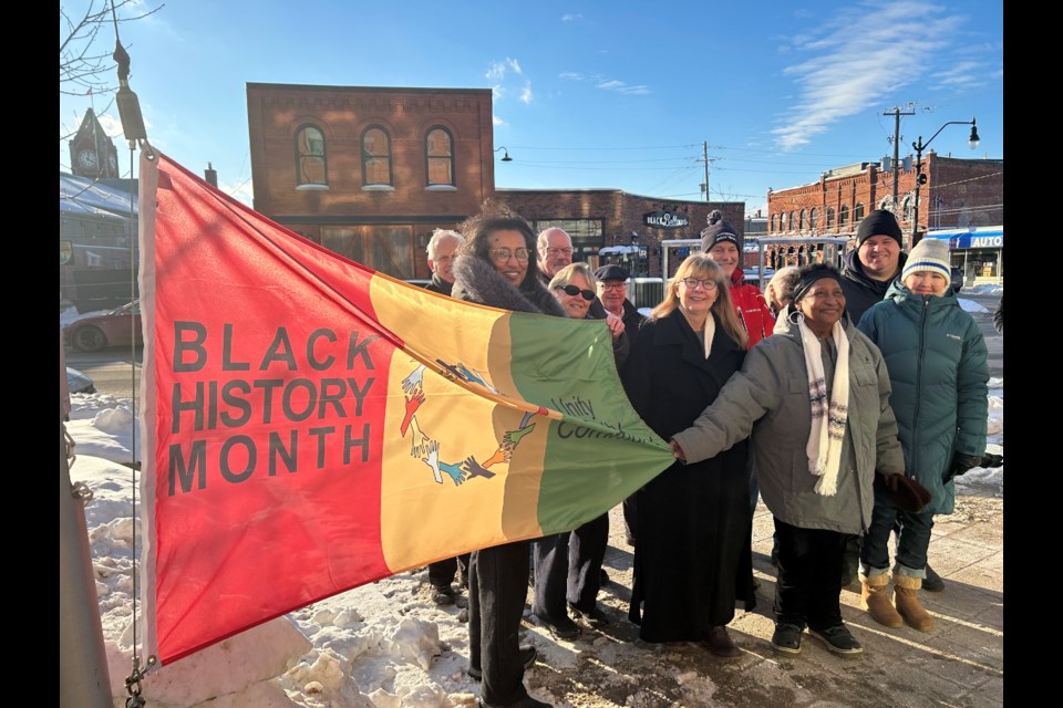 Town council and guests helped raise the flag for Black History Month at the Collingwood Public Library. The flag's design was created by the Collingwood Unity Collective. 