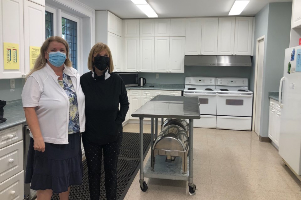 Susan Scouten and Kathleen Wilkinson at the kitchen at All Saints' Anglican Church, where they prepare all the food for both monthly Friendship Dinners and weekly Entrees-to-Go. 
