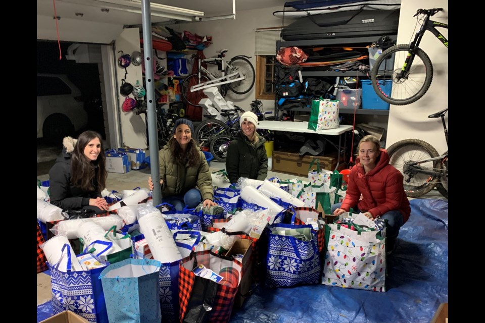From left Monica Calzaretto, Monica Piccininno, Sarah Abawi, and Becky Craig pack up donations from individuals and businesses to be distributed to Wasaga Beach families in low income situations. Contributed photo