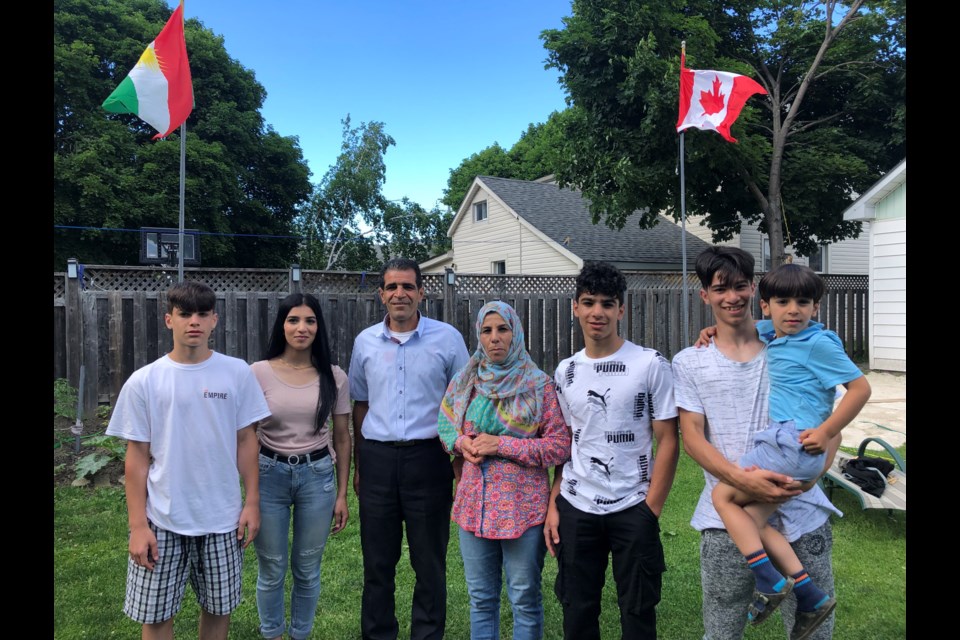 The Bozan family in their Collingwood backyard where they fly the Kurdish and Canadian flags. 