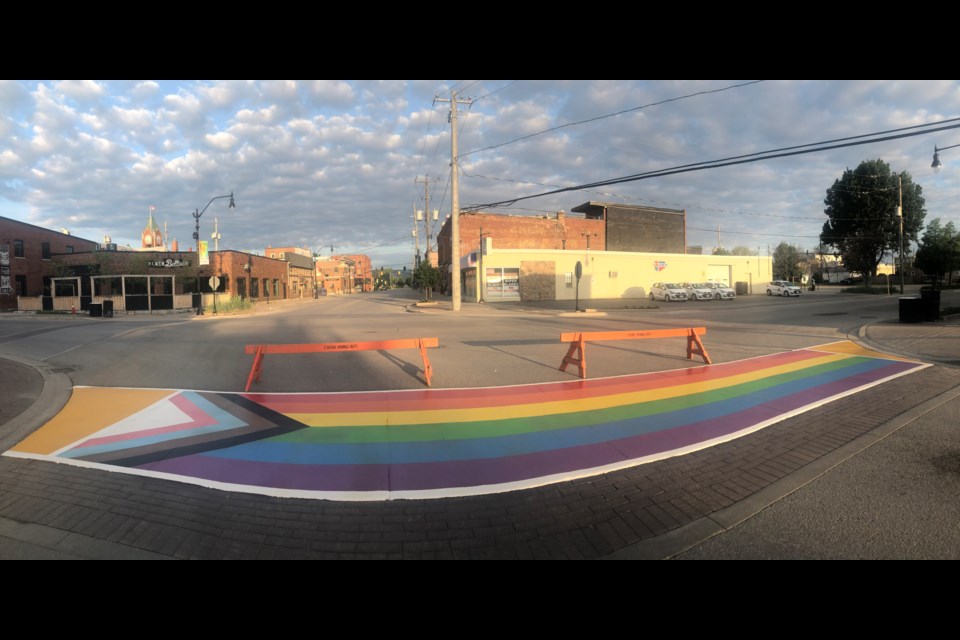 The rainbow crosswalk at the intersection of Ste. Marie and Simcoe Streets. *Note the shape of the crosswalk is distorted because of the panoramic image