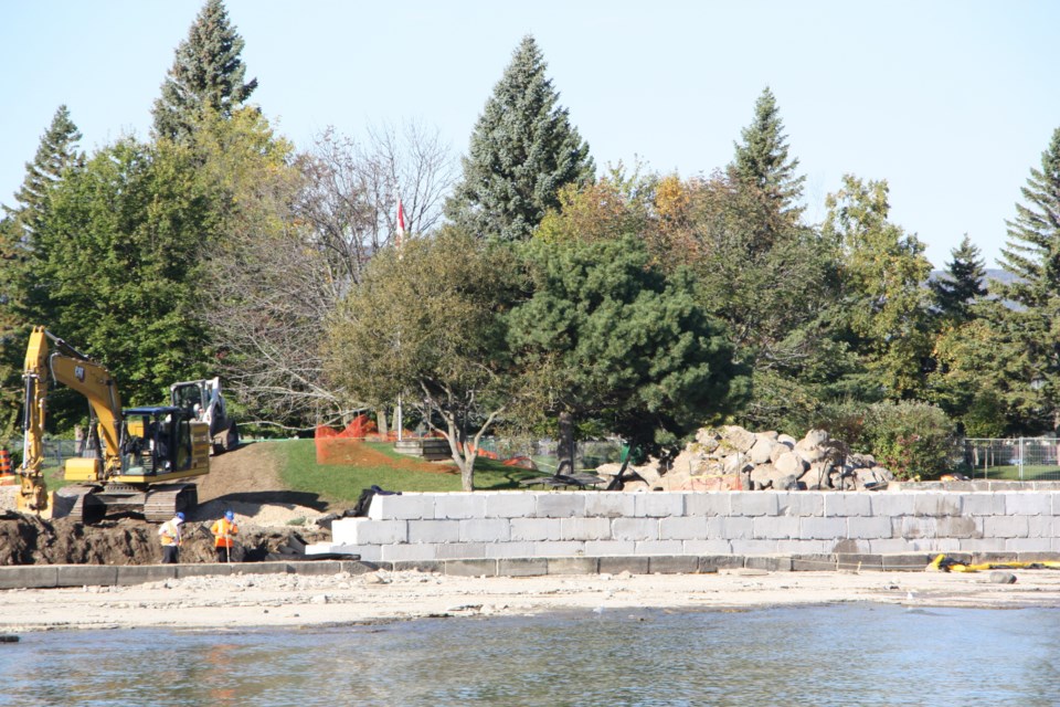 A concrete wall under construction at Sunset Point is meant to reinforce the shoreline to prevent erosion damage. 