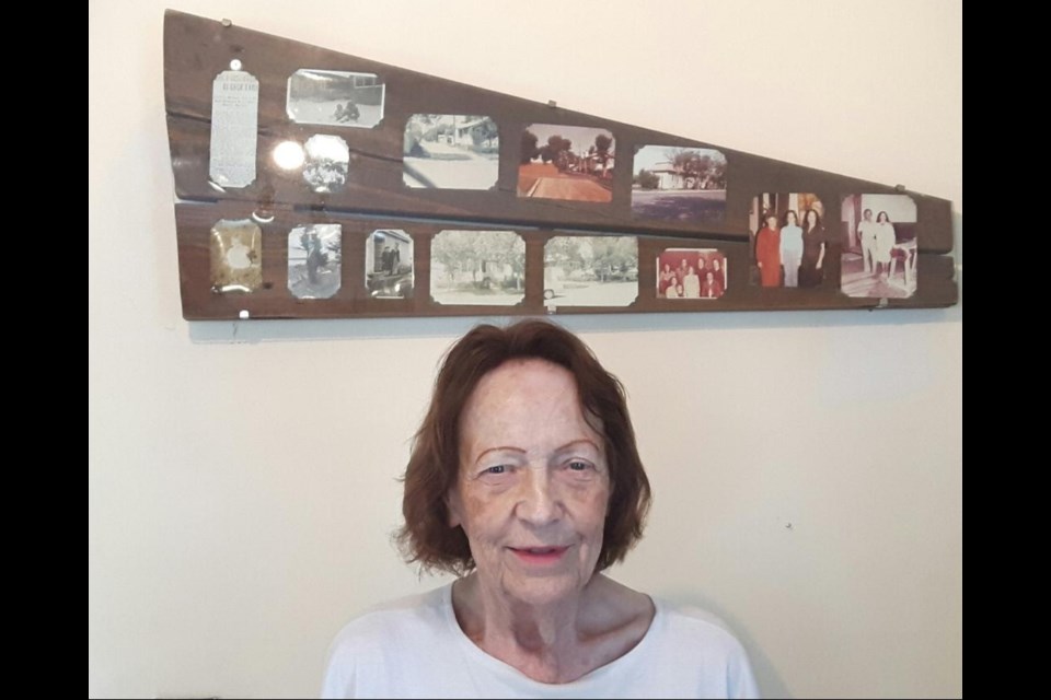 Jean Fish brought home the boards from the place on the sidewalk where she was found as an abandoned baby. The boards are pictured here in the background adorned with family photos. Contributed photo 
