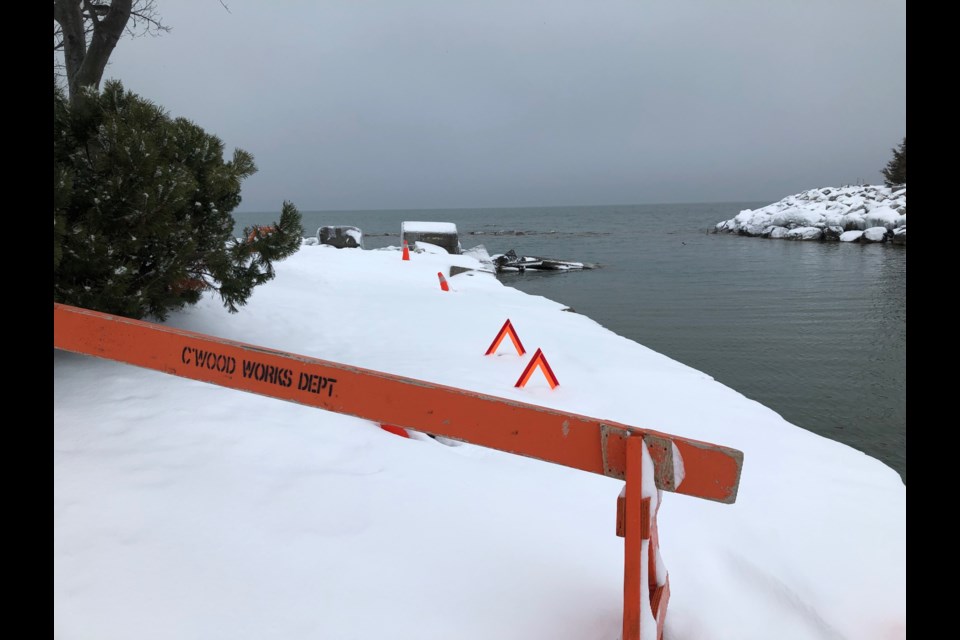 Orange barricades put up by the town's parks department aim to steer park visitors away from sink holes and eroded portions of the shoreline until they can be backfilled. Erika Engel/CollingwoodToday