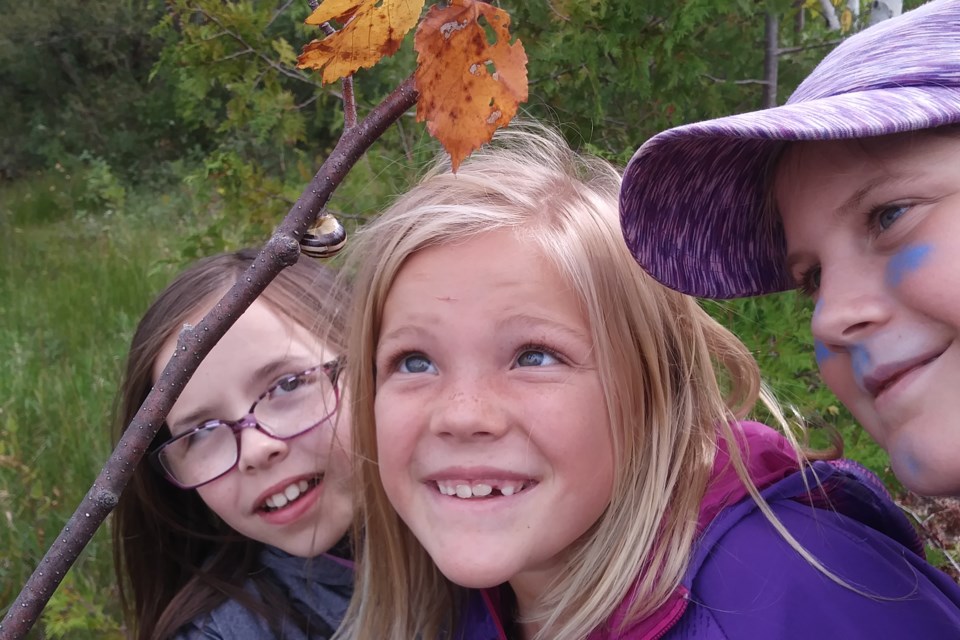 Students at Free Spirit Forest and Nature School discover a creature to learn more about. Contributed photo