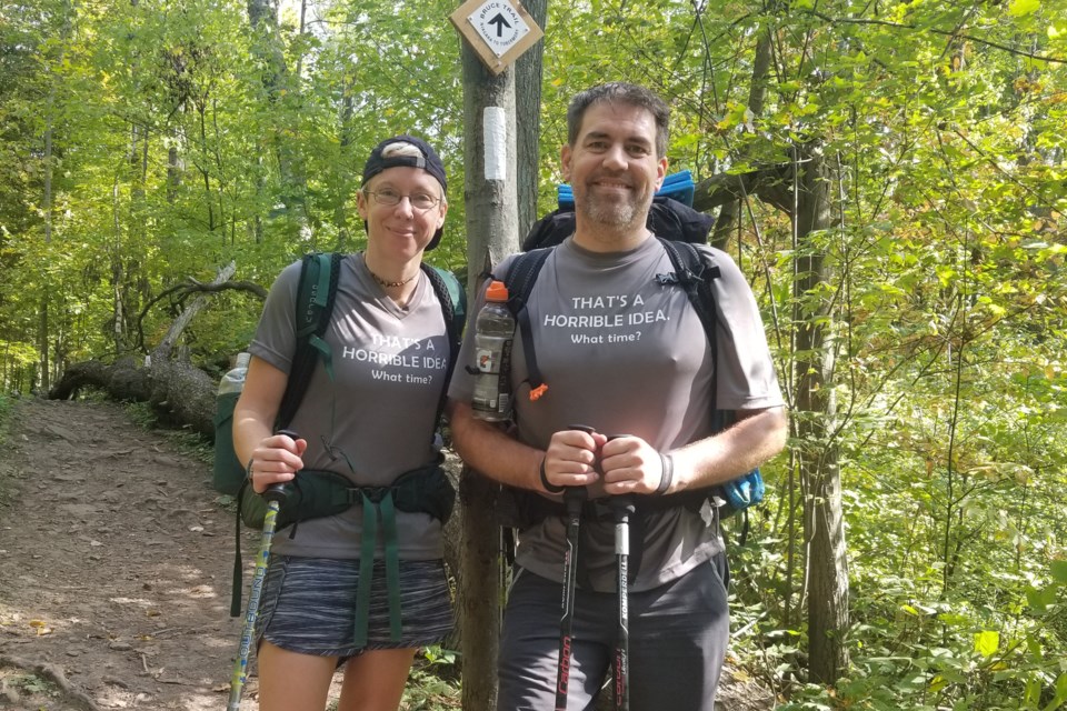 Tyler Gibson with Kelly Doner, a friend who joined him for a portion of his Bruce Trail hike. Both are wearing t-shirts they had made for the occasion. The shirts say 