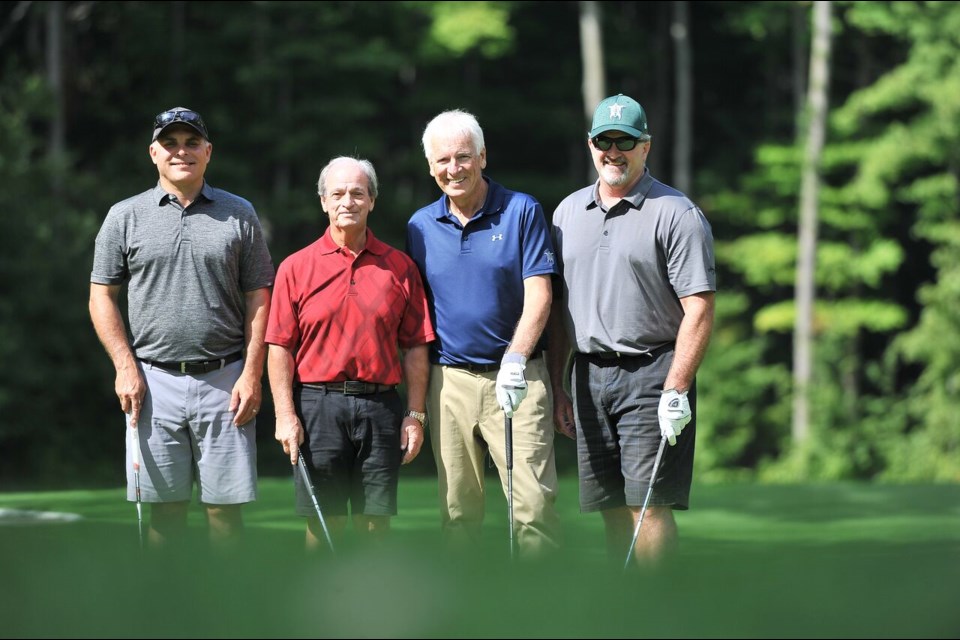 Cal Patterson (in the red shirt) in the Warden's Golf Tournament with Jim Hartman, Mark Palmer and Terry Geddes.