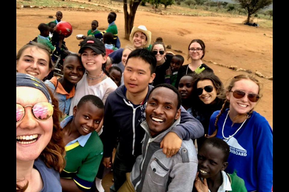 Beth Dennis (far left bottom) takes a selfie with fellow WE trippers and some of the friends they made in Tanzania. Contributed photo.