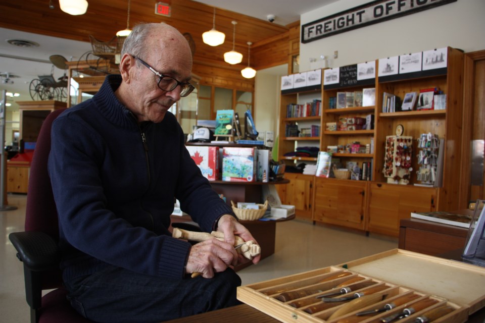 Garry Reid demonstrates some carving on a figure he's been working on. Reid has been carving since his days at senior public school when his teacher introduced him to the craft. Erika Engel/CollingwoodToday