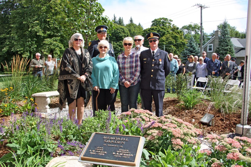 The family of Chief Dance and Sgt. McKean unveiled the old plaque at the new memorial garden honouring the memories of the Fire Chief and the police officer who died while on duty in Collingwood. From left: Ann Gage (wife of Sgt. Ron McKean), OPP officer Trevor McKean (son of Sgt. McKean), Sharon McKean (Sgt. McKeanâs sister-in-law), Cherolyn McKee (Sgt. McKeanâs sister), Kenneth McKean (Sgt. McKeanâs brother) and retired captain William Dance of the Collingwood Fire Department (Chief Danceâs nephew). Erika Engel/CollingwoodToday
