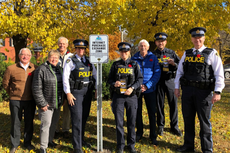 Collingwood OPP and the Town of Collingwood celebrated the launch of Project Safe Trade in Collingwood with an Internet Purchase Exchange Zone located in the parking lot of the Collingwood OPP detachment. 
Left to Right: Christopher Baines of the Police Services Board, Councillor Kathy Jeffery, Councillor Tim Fryer, Detachment Commander Insp. Mary Shannon, Community Safety Officer Const. Marcey Rivers, Councillor Mike Edwards, Media Relations Officer Const. Martin Hachey, and Staff Sgt. Terry Ward. Erika Engel/CollingwoodToday