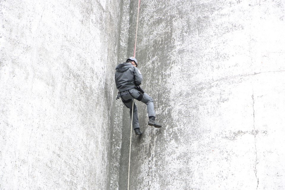 Const. Doug McLellan, from the Barrie Police Tactical Unit rappels down the Collingwood Terminals building.
