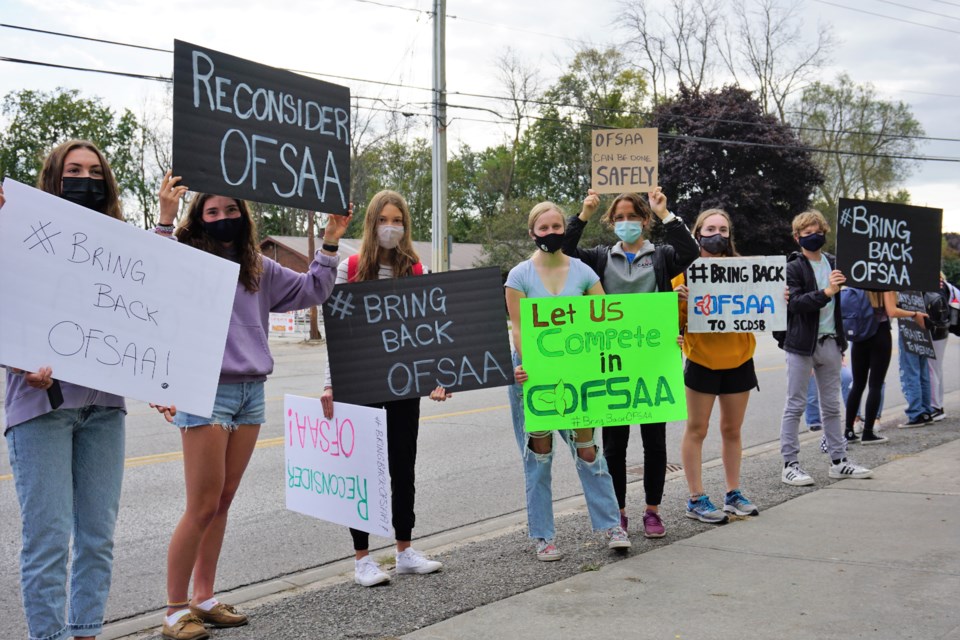 About 20 students from Collingwood Collegiate Institute lined Hurontario Street on Thursday morning to protest the Simcoe County District School Board's decision to withdraw from OFSAA championships for the fall season.