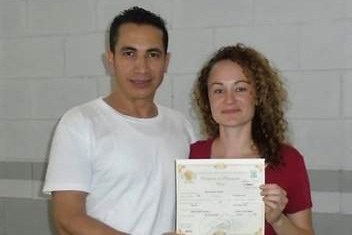 Edwin Espinal and Karen Spring on their wedding day. They are holding their marriage certificate. The ceremony took place at the chapel at La Tolva prison, a military-run maximum security prison in Honduras. Contributed photo