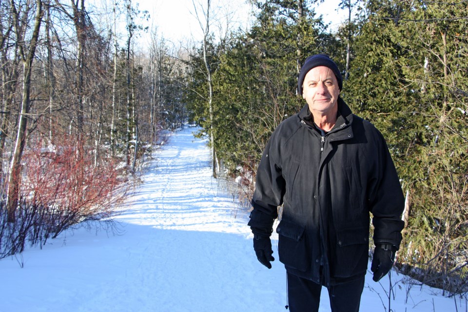 Wayne Caswill stands at the start of the 11th Line trail to begin his regular survey of the trail conditions. Heâll pick up garbage along the way and check-in with any hikers he meets. As trail captain, heâs an ambassador for Collingwoodâs trails and the eyes and ears for the town when it comes to his section of trail - the George Christie Nature Trails. Erika Engel/CollingwoodToday