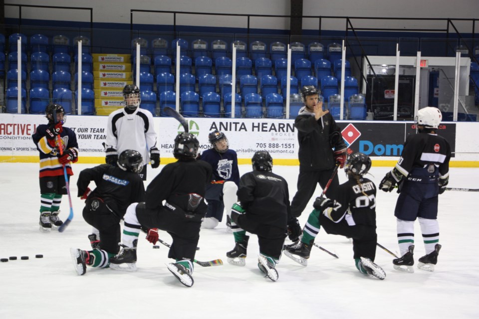 Teacher Todd Hammond works with CCI students and elementary students from Worsley (Wasaga Beach) during a morning class leading up to Hockey Day in Collingwood. Hammond has invited local elementary schools to join the high school class for a free hockey lesson. Erika Engel/CollingwoodToday