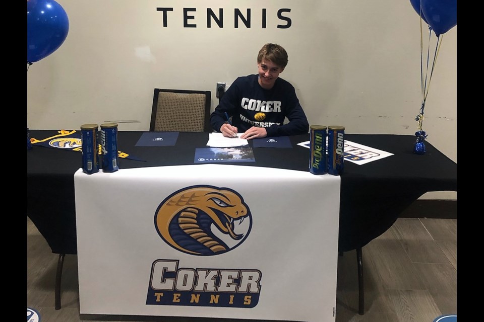 Nolan Smith signs a letter of intent with Coker University after receiving both an academic and athletic scholarship from the South Carolina school.