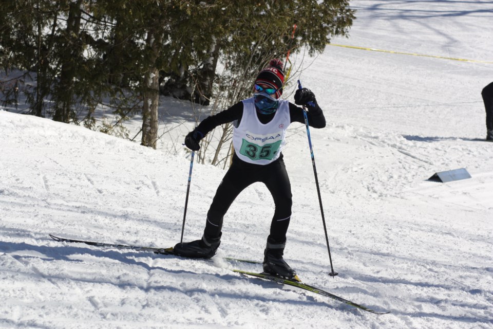 A junior boy's relay team skier from St. Mary's DCVI pushes up a hill. Erika Engel/CollingwoodToday