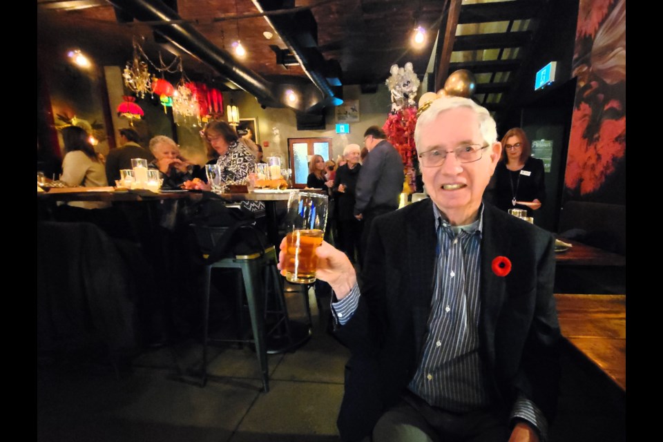 George Weider, former president and founder of South Georgian Bay Tourism, raises a glass during the organization's 45th anniversary celebration at Black Bellows on Nov. 8, 2023.