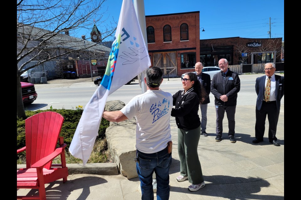 Flag designer Elettra Di Cintio helps raise the flag to celebrate Earth Day on April 22, 2024.