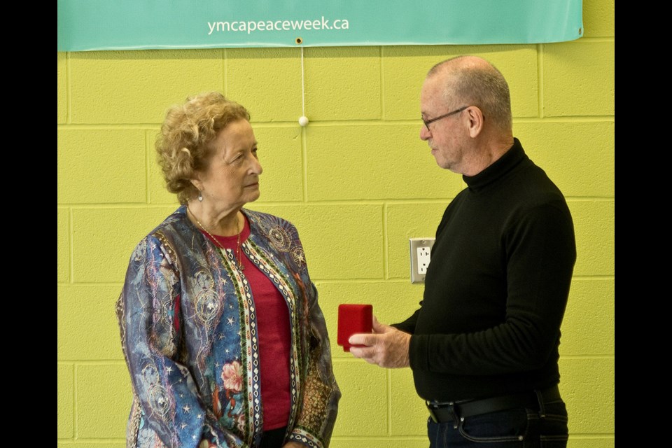 Lynn Silverton receives the YMCA of Owen Sound Grey Bruce 2022 Peace Medal from Brian Minielly of the peace medal committee.