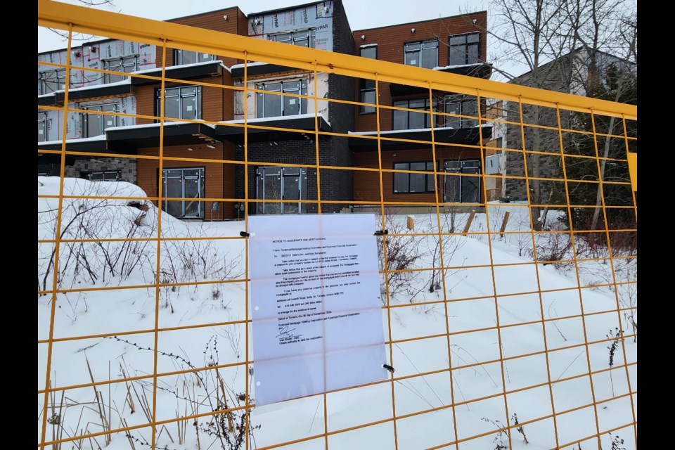 A notice on the fence surrounding the Towns of Thornbury project says the development has been taken over by the mortgage company.