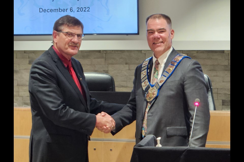 Past warden Kevin Eccles presented the chain of office to new warden Brian Milne.